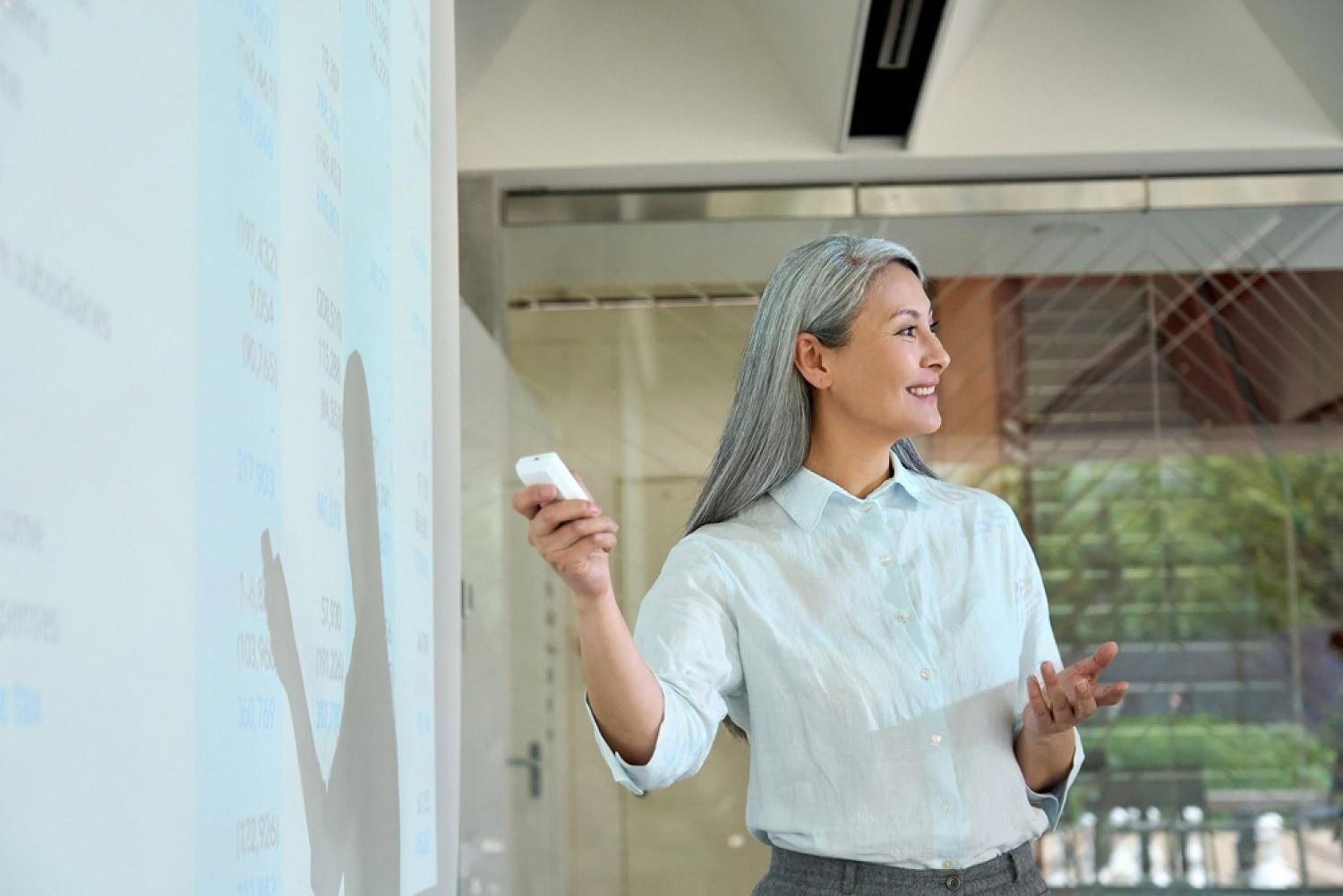 Female leader presenting financial data to a team during a strategy meeting